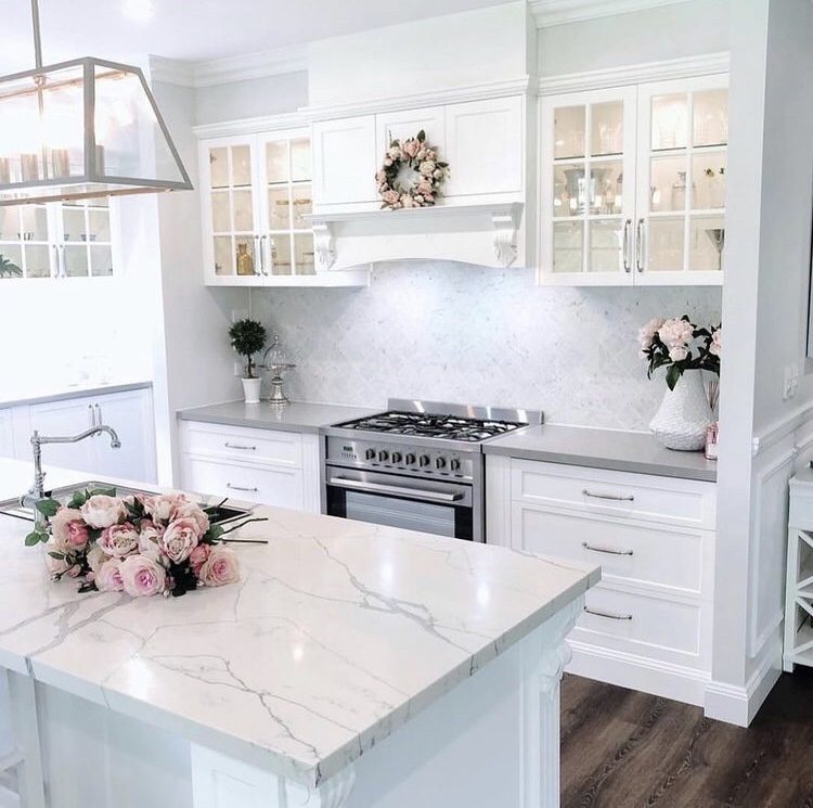 all white kitchen with marble countertops 