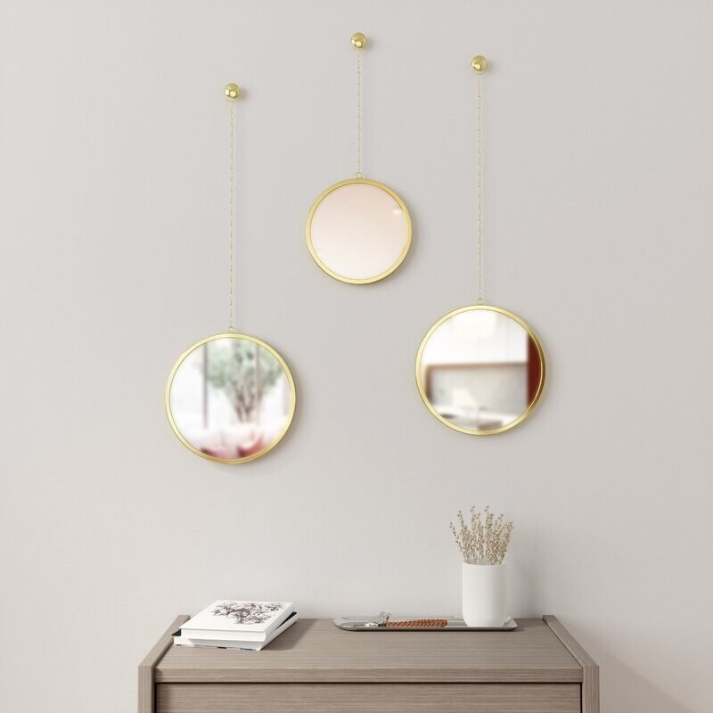 Hanging mirrors in a hallway with sideboard 