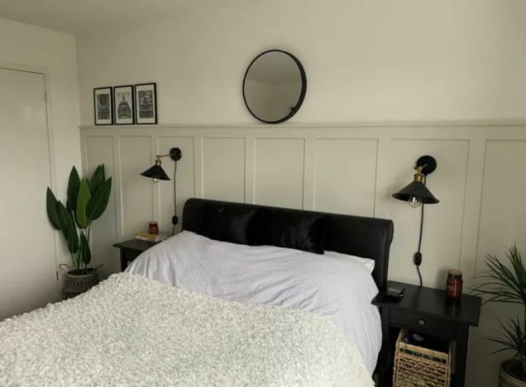 Image of a white bedroom with half wall panelling with shelves