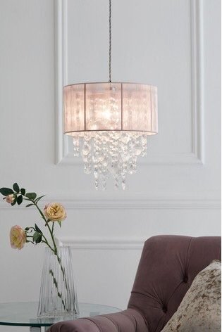 white living room with pink pendant light 