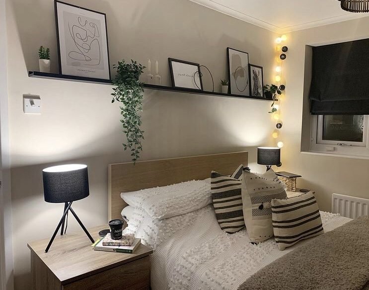 Image of a small bedroom with wall shelves