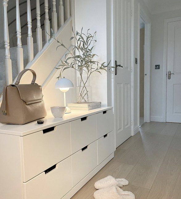 hallway console table ideas - white storage table in a white hallway