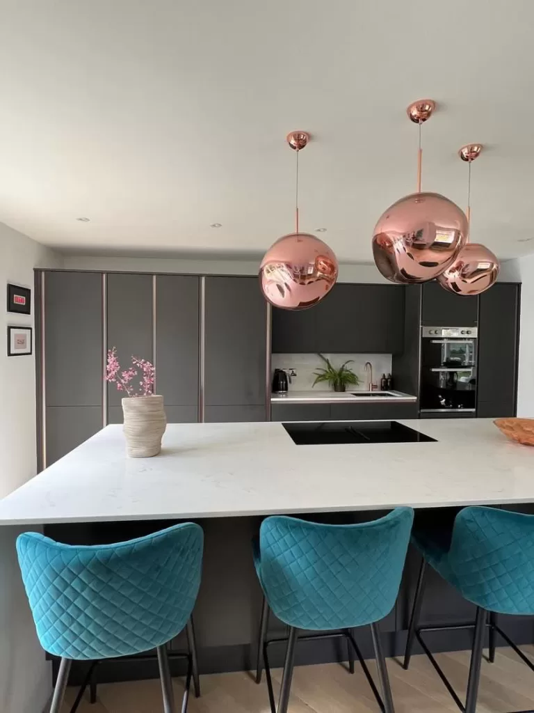 1970s home gets a kitchen transformation with a hidden door - kitchen with island and pendant lights