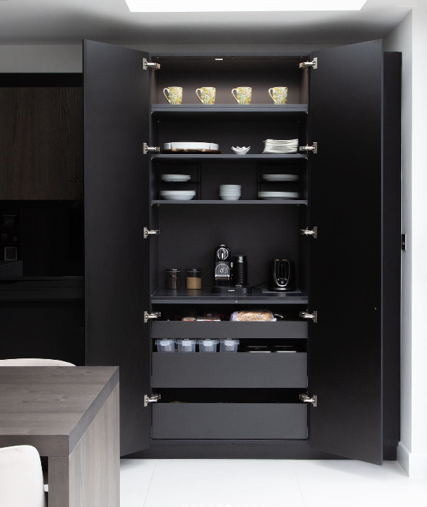 black kitchen with hidden spice cabinet pantry open