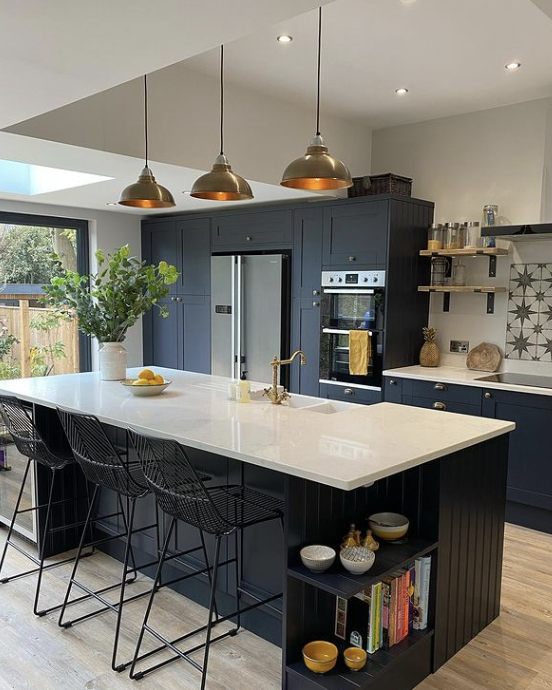 blue kitchen with hidden cabinets and pantry