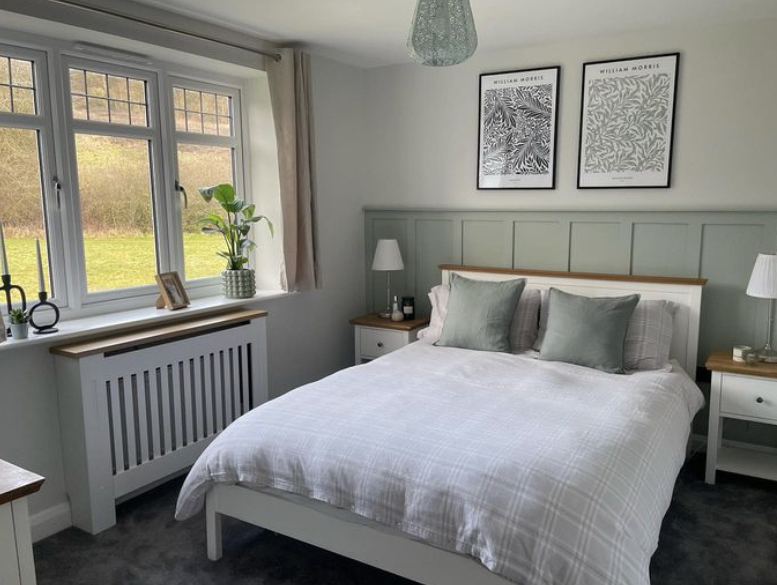 sage green panelling in a bedroom with white walls