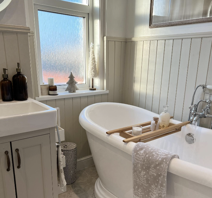 white and grey bathroom with slat panelling with statement bathtub