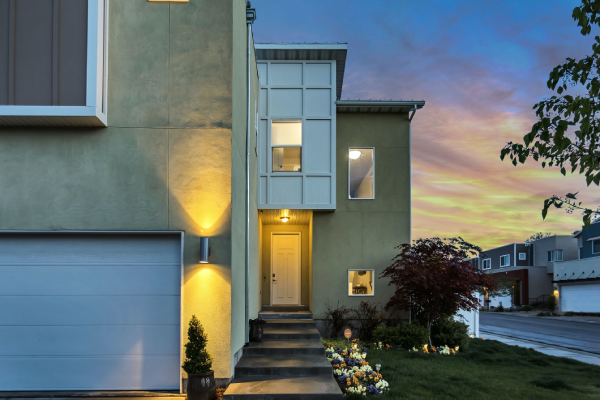 This photograph is of a beautiful home decorated with plants, trees, and flowers