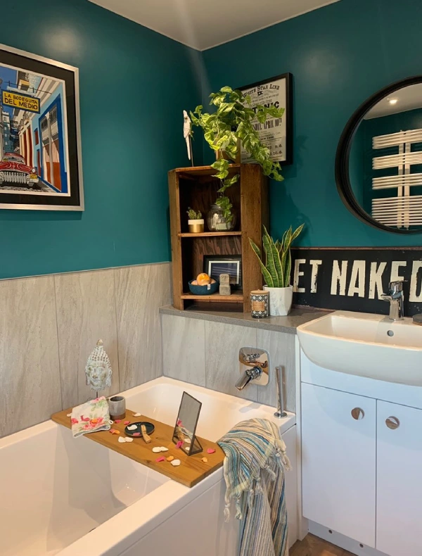 blue eclectic bathroom with grey tiles and plants