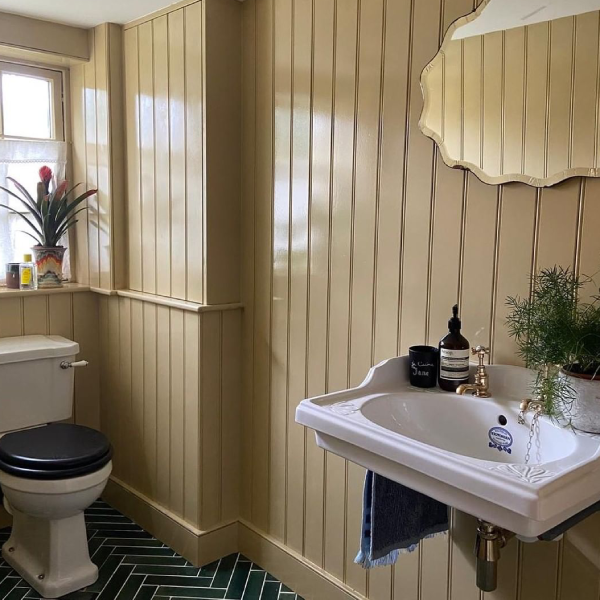 cream panelling floor to ceiling in a downstairs toilet to make it look more quirky