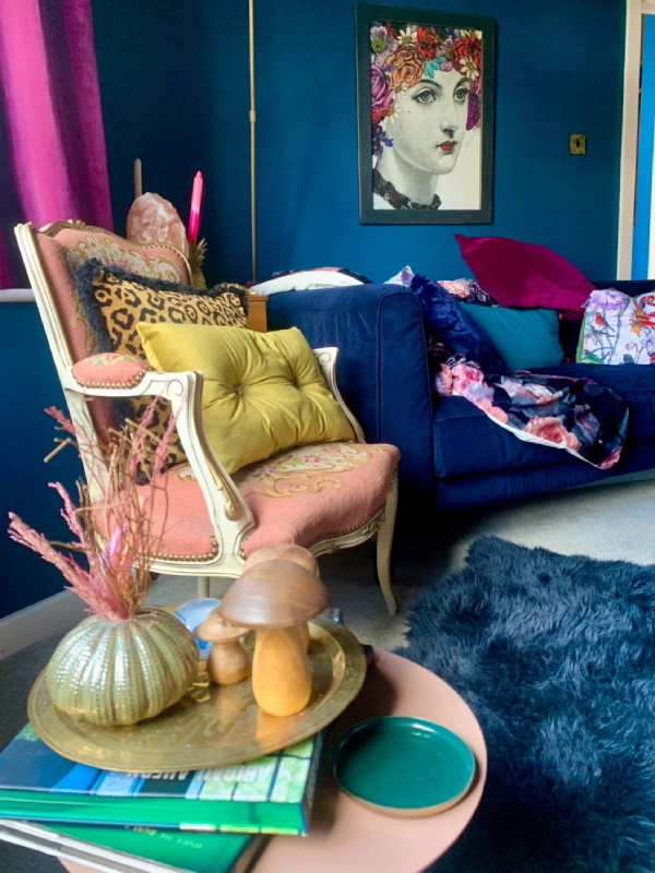 eclectic living room with blue walls and sofa and yellow accessories