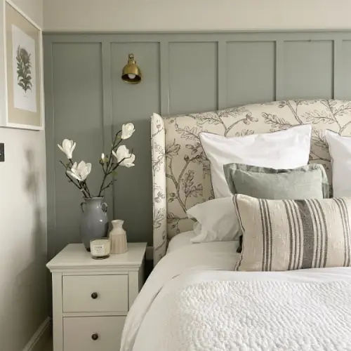 sage green bedroom with floral and white decor - green colour trends 2023