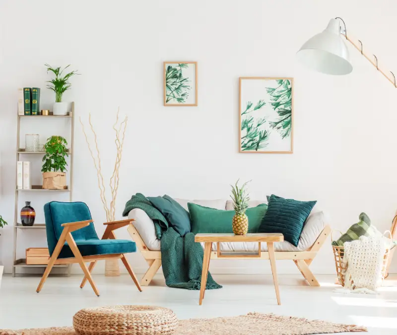 boho living room with green plants and artwork to match