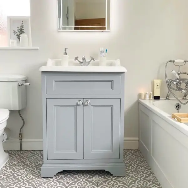 Use grey cabinets to break up a white bathroom