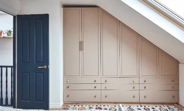 bedroom with built in pink wardrobe storage