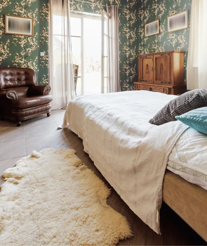 cozy and maximalist bedroom with floral wallpaper