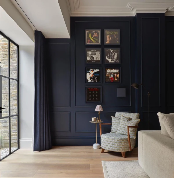 dark blue living room with moulding panel walls