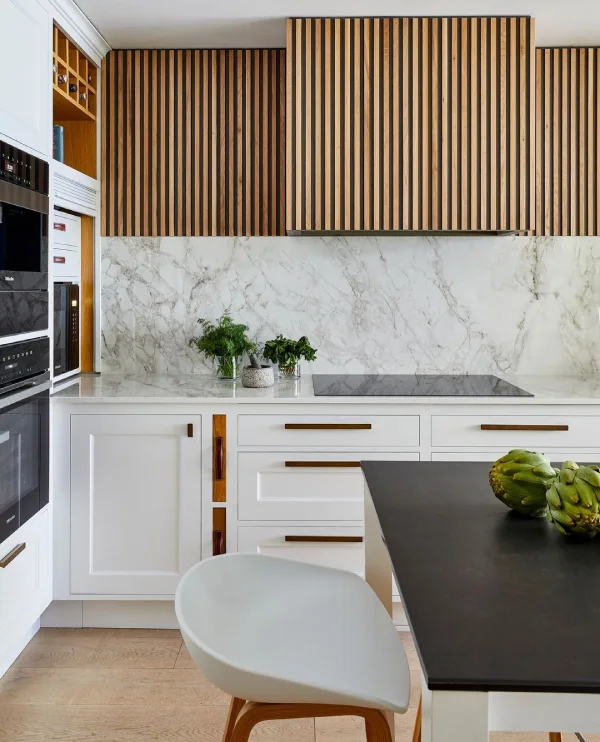 marble kitchen with wood slat panelled cabinets