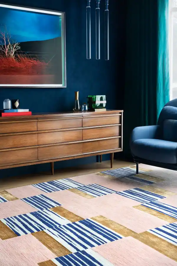 Bold pink rug with blue and gold for a living room