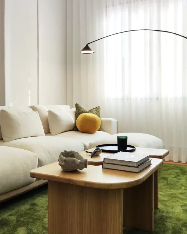 green living room with white sofa and oak coffee table