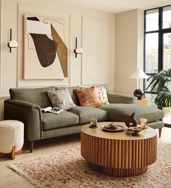 2024 living room trends - warm spaces and sage green sofa