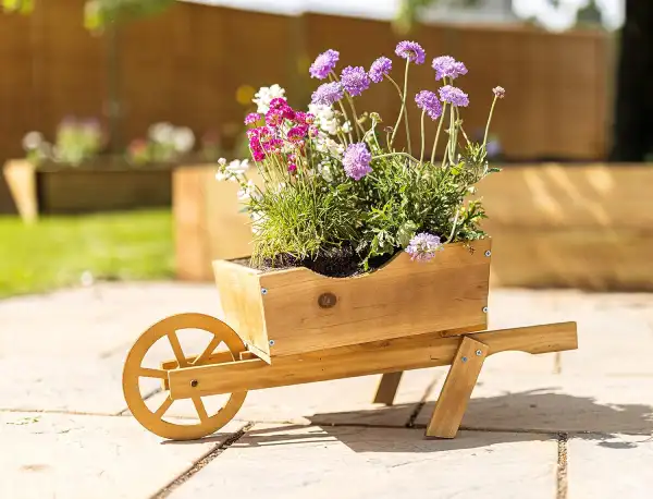 wooden planter shaped as a wheelbarrow