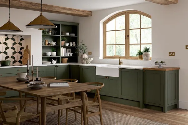 Elegant forest green cabinets and wood beams 