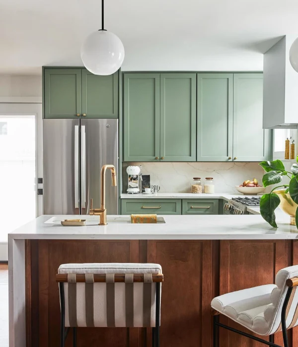 kitchen with sage green cabinets and wood island