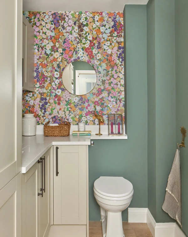 toilet with farrow and ball smoke green walls and floral wallpaper