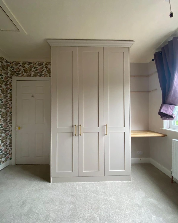 fitted wardrobes in a bedroom painted in farrow and ball elephants breath