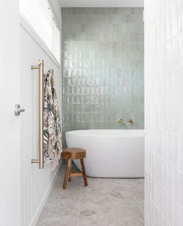 white bathroom with sage green tiles