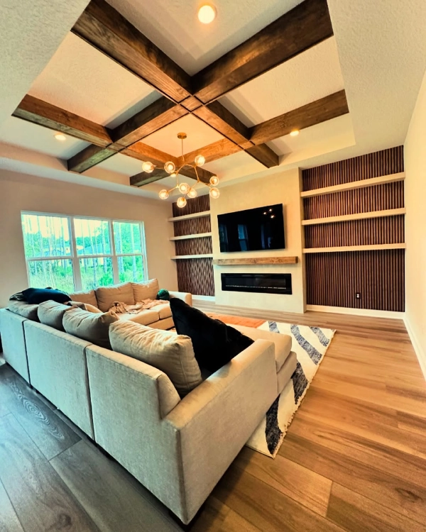 living room with fireplace alcove accent wall and beamed ceiling - farmhouse style living room