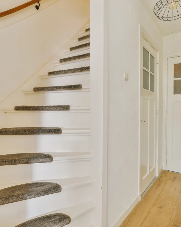 white hallway and stairs with stair treads