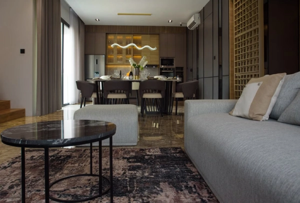 luxurious open plan living room and kitchen in dark furniture for a moody look