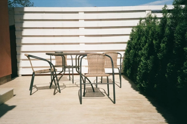 rattan and meta patio furnishings for a minimalist patio